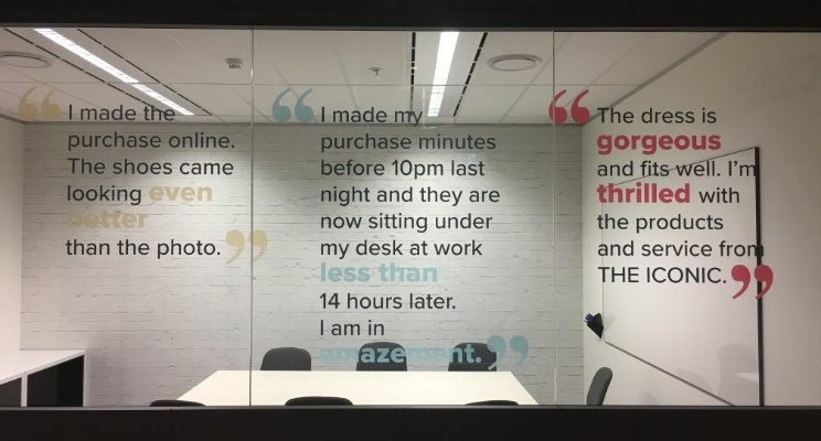 A meeting room at THE ICONIC - They value their Customer feedback so much as they use it as office decor